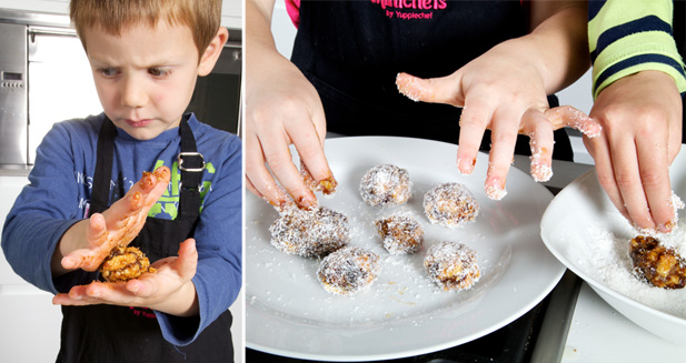 Rolling date balls in coconut Adding coconut layer to rolled date balls